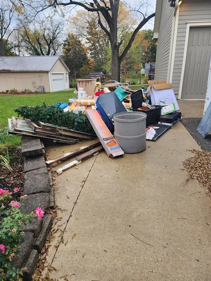 Dumpster being loaded with debris for 12 Yard Dumpster Rental in Rusk